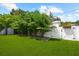 Landscaped backyard and lawn surrounded by a privacy fence and greenery at 2707 Ridgewood Ave, Tampa, FL 33602