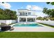 Outdoor living area featuring pool, in-pool loungers, spa, and covered patio at 2707 Ridgewood Ave, Tampa, FL 33602