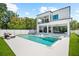 Modern two-story home with a pool, hot tub, and outdoor living space at 2707 Ridgewood Ave, Tampa, FL 33602