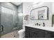 Modern bathroom features a tiled shower, sleek vanity, and neutral tones at 2707 Ridgewood Ave, Tampa, FL 33602