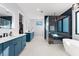 Bright bathroom featuring dual vanities, modern fixtures, and a glass-enclosed shower with a separate soaking tub at 2707 Ridgewood Ave, Tampa, FL 33602