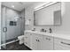 Modern bathroom with a glass walk-in shower, vanity, and a white countertop with undermount sink at 2707 Ridgewood Ave, Tampa, FL 33602