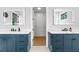 Dual sink bathroom vanity with modern lighting fixtures, marble countertop, and a doorway to a walk-in closet at 2707 Ridgewood Ave, Tampa, FL 33602