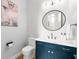 Modern half bathroom with blue vanity and marble countertops at 2707 Ridgewood Ave, Tampa, FL 33602