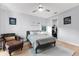 Well-lit bedroom featuring a ceiling fan, area rug, chair and adjacent table, and wall decor at 2707 Ridgewood Ave, Tampa, FL 33602