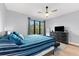 This bedroom is furnished with a dresser and large windows overlooking the exterior at 2707 Ridgewood Ave, Tampa, FL 33602