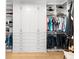 Spacious walk-in closet featuring custom shelving, cabinets, and hanging rods for optimal storage at 2707 Ridgewood Ave, Tampa, FL 33602
