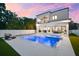 A modern home features a stunning backyard pool, patio, and outdoor living space at 2707 Ridgewood Ave, Tampa, FL 33602