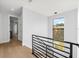 Upstairs hallway with modern railings and hardwood floors, bright natural light at 2707 Ridgewood Ave, Tampa, FL 33602