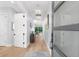 Inviting foyer featuring a light-filled hallway, light hardwood floors, and modern décor at 2707 Ridgewood Ave, Tampa, FL 33602