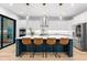 Kitchen featuring white cabinets, stainless steel appliances, a center island with barstool seating, and natural light at 2707 Ridgewood Ave, Tampa, FL 33602