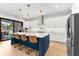 Modern kitchen featuring white cabinets, stainless steel appliances, a center island with seating, and natural light at 2707 Ridgewood Ave, Tampa, FL 33602