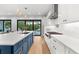 Modern kitchen with white countertops, and stainless steel appliances with outdoor view to the pool at 2707 Ridgewood Ave, Tampa, FL 33602