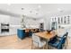 Kitchen featuring a large island with barstool seating, white cabinets, and stainless steel appliances at 2707 Ridgewood Ave, Tampa, FL 33602