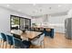 Bright kitchen with white cabinets, a large island, stainless steel appliances and an adjacent dining area at 2707 Ridgewood Ave, Tampa, FL 33602