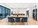 Eat-in kitchen features a dining area, white cabinets, stainless steel appliances, and a blue kitchen island at 2707 Ridgewood Ave, Tampa, FL 33602