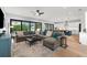 Bright, open-concept living room boasts a large sectional sofa, light wood floors, and seamless access to the outdoors at 2707 Ridgewood Ave, Tampa, FL 33602