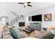 Stylish living room features an open staircase, a large sectional sofa, and modern decor at 2707 Ridgewood Ave, Tampa, FL 33602