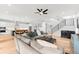Spacious, open-concept living room blends seamlessly with the kitchen and staircase in a modern design at 2707 Ridgewood Ave, Tampa, FL 33602