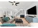 Comfortable living room with a large sectional sofa, modern decor, and an open staircase at 2707 Ridgewood Ave, Tampa, FL 33602