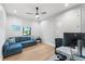 This home office features an exterior window, a ceiling fan, and a sofa for relaxation at 2707 Ridgewood Ave, Tampa, FL 33602