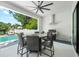This covered outdoor kitchen and dining area is next to the pool for easy entertaining at 2707 Ridgewood Ave, Tampa, FL 33602