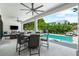 This covered outdoor space overlooks the pool with a dining area and comfortable lounge at 2707 Ridgewood Ave, Tampa, FL 33602