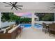 Covered patio featuring comfortable seating overlooking pool and backyard at 2707 Ridgewood Ave, Tampa, FL 33602