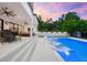 A covered patio overlooks the pool and spa, perfect for relaxing outdoors at 2707 Ridgewood Ave, Tampa, FL 33602