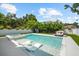 A modern pool with integrated spa, sun loungers, and an outdoor daybed offers a luxurious retreat at 2707 Ridgewood Ave, Tampa, FL 33602