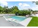 Inviting backyard pool features in-pool loungers, a hot tub, and turf surround at 2707 Ridgewood Ave, Tampa, FL 33602