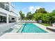Modern home features a pool with in-pool loungers, hot tub, and outdoor entertaining space at 2707 Ridgewood Ave, Tampa, FL 33602