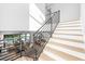Staircase with black metal railings and hardwood steps, offering a view of the living area at 2707 Ridgewood Ave, Tampa, FL 33602
