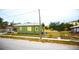 Exterior street-side view of two-story home with a fenced yard and grass at 3009 N 13Th St, Tampa, FL 33605