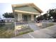 Charming front exterior view of a two-story home with a fenced yard and a cozy front porch at 3009 N 13Th St, Tampa, FL 33605