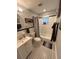 Traditional bathroom featuring a shower-tub combo and black and white tile floor at 302 W Fern St, Tampa, FL 33604