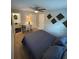Comfortable bedroom with neutral carpet, a ceiling fan, and a view into the ensuite bathroom at 302 W Fern St, Tampa, FL 33604