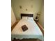 Cozy bedroom with neutral walls, tan carpet, and a bed with white patterned quilt at 302 W Fern St, Tampa, FL 33604