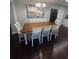 Formal dining area with hardwood floors, an extending wooden table, and seating for six, perfect for Gathering gatherings at 302 W Fern St, Tampa, FL 33604