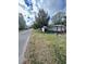 Charming single-story home with manicured lawn, lush greenery and tree views at 302 W Fern St, Tampa, FL 33604