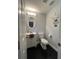 Small bathroom featuring black tile flooring, a stylish vanity, and modern lighting at 302 W Fern St, Tampa, FL 33604