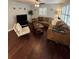 Spacious living room featuring hardwood floors, plantation shutters, a comfortable brown sectional sofa, and neutral wall color at 302 W Fern St, Tampa, FL 33604