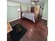 Cozy bedroom features hardwood floors, soft green walls, and a ceiling fan at 302 W Fern St, Tampa, FL 33604