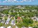 Aerial view of the property featuring the home, backyard, pool and mature trees at 317 Elizabeth Ave, Clearwater, FL 33759
