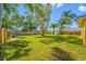 Lush backyard featuring a shed, mature trees and a wooden fence at 317 Elizabeth Ave, Clearwater, FL 33759