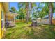 Backyard featuring a shed, mature trees and partially covered porch at 317 Elizabeth Ave, Clearwater, FL 33759