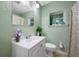 Cozy bathroom with a white vanity, and a well-lit mirror, creating a fresh and inviting space at 317 Elizabeth Ave, Clearwater, FL 33759