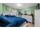 Comfortable bedroom with a bright blue bedspread and white dresser, creating a tranquil and inviting space at 317 Elizabeth Ave, Clearwater, FL 33759