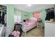 Bright bedroom with a pink bed and a white dresser, creating a peaceful and inviting space at 317 Elizabeth Ave, Clearwater, FL 33759