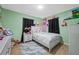 Charming bedroom with a white bed frame and a view into a lovely decorated room at 317 Elizabeth Ave, Clearwater, FL 33759